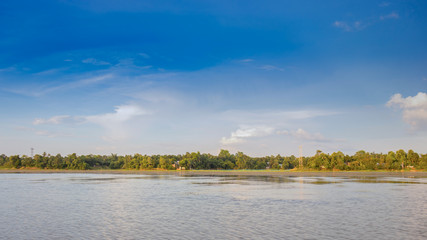 Beautiful view of blue skyline, forest and calm water as viewed from a lake Twijilikma, Tripura, India