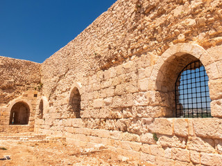 Ancient fortress walls with embrasures and metal bars. Kizkalesi, Mersin province, Turkey