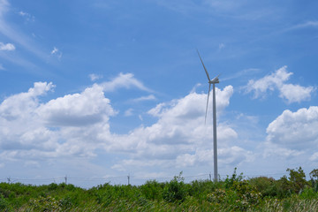 Wind turbine farm to generate the electric power with blue sky and cloudy day