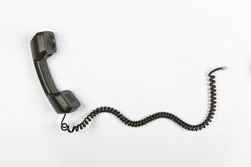 Call center concept, public relations, gossip, rumors. Telephone receiver with wire on a white...
