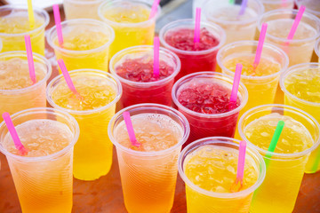 Colorful soft drink in plastic cup - 285599567