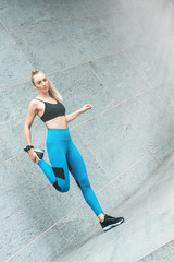 In Pursuit of Good Shape. Fitness girl doing stretching, morning exercises. Copy space in upper right part