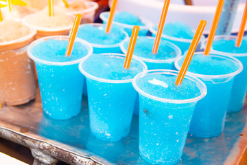 Colorful soft drink in plastic cup
