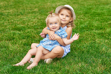 sisters in the park, two girls on a summer picnic