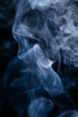 Blue smoke waves on black background