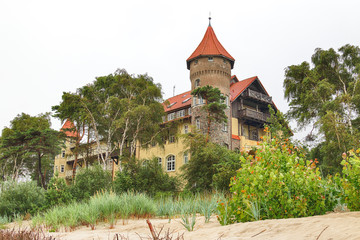 LEBA, POLAND - JULY 23, 2019: Neptun Castle on the Baltic Sea in Leba, Poland. In 1903 almost on the beach , the build of this interesting architectonically building was begun (completed in 1907). © promesaartstudio