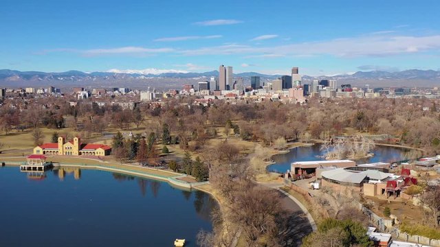Good aerial of downtown Denver Colorado skyline from large lake at City Park.