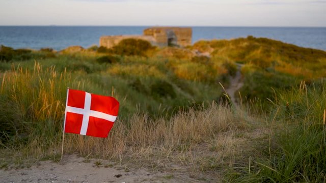 Danish flag on the beach of Grenen, the northernmost part of Denmark.