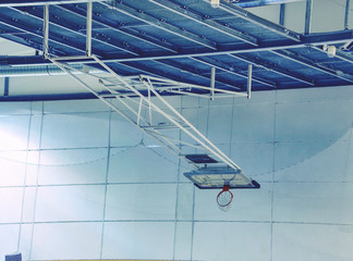 Fototapeta premium Fold orange basketball hoop with white net in indoor gym