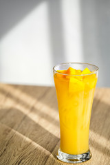 Mango Boba Bubble Milk Tea with bubble topping for tea or other beverage on the wood table with copy-space for textures and wall Natural light background