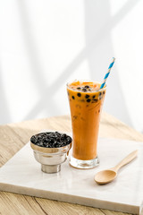 Bubble milk tea with bubble topping for tea or other beverage on the wood table with copy-space for textures and wall Natural light background
