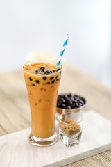 Bubble milk tea with bubble topping for tea or other beverage on the wood table with copy-space for textures and wall Natural light background