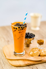 Bubble milk tea with bubble topping for tea or other beverage on the wood table with copy-space for textures and wall Natural light background