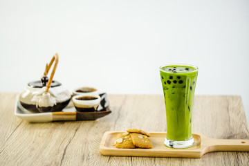 Bubble milk green tea with bubble topping for tea or other beverage on the wood table with copy-space for textures and wall Natural light background