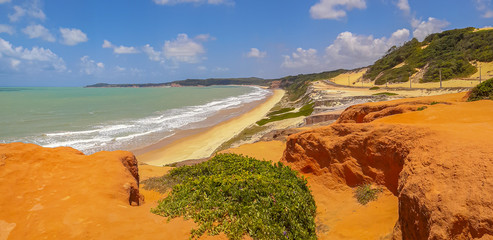 Panorama of brasilian beach with dunes bathed by ocean waves, Pipa, Natal, Brasil