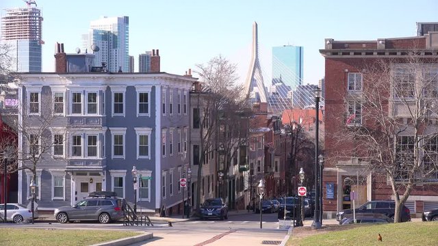 Establishing shot of apartments and streets on Bunker Hill, Boston, Massachusetts with Leonard P. Zakim Bunker Hill Memorial Bridge background.