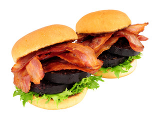 Fried bacon and black pudding sandwich rolls with lettuce isolated on a white background