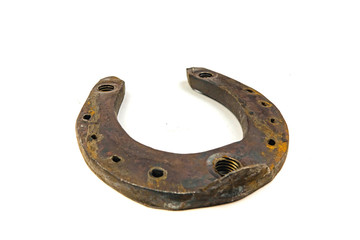 Old rusty horseshoe on a white background.