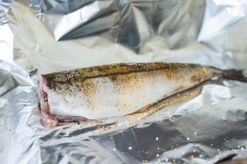 fish is prepared in foil with spices in the oven