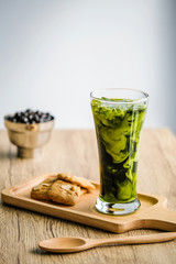 Bubble milk green tea with bubble topping for tea or other beverage on the wood table with copy-space for textures and wall Natural light background