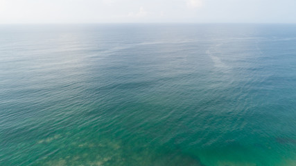 Aerial view of mystery sea surface under blue sky