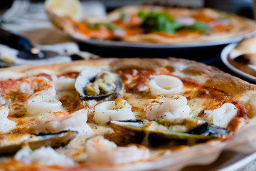 close up seafood pizza on dish
