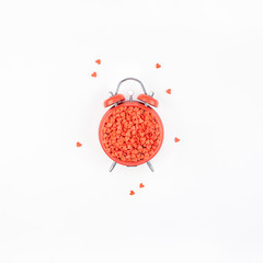 Valentine Day concept with alarm clock and hearts