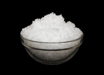 Coarse organic sea salt in bowl isolated on black background
