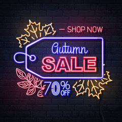 Neon sign autumn big sale with maple leaves on brick background. Vintage electric signboard.