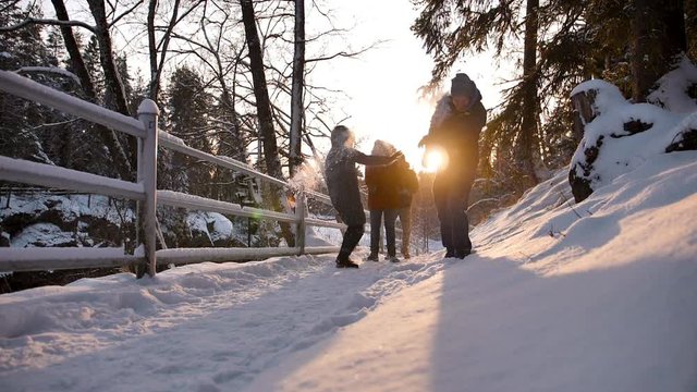 Group of happy close friends jumps in winter forest