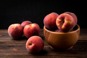 Peach on dark wooden background.