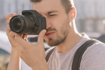 Fototapeta na wymiar Photographer taking photo on dslr camera in the city