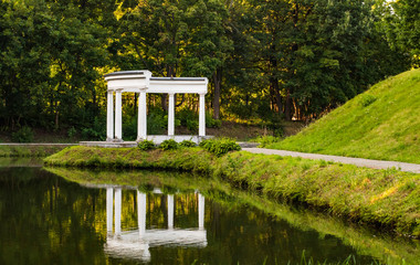 Small building with columns and no roof near the water