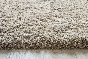 carpet high pile of threads of different thicknesses and weaving on the wooden floor. Shaggy carpet