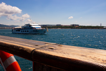 Metal new ship sails from the port with the historically old ship in the open sea