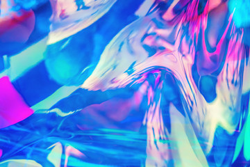 Abstract blurred texture in blue, magenta, pink and mint colors. Trendy holographic background in 80s style. Bright neon colors.