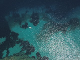 Top View Slow motion looping c ripples and wave, Refraction of sunlight top view texture sea side, Foaming and Splashing in the Ocean, Sunny Day, Slow Motion Video. Halkidiki, Greece. Veiw from drone