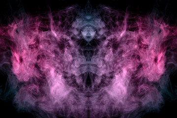 Smoke of different blue, red and pink colors in form of horror in the shape of the head, face and eye with wings on a black isolated background. Soul and ghost in mystical symbol. Print for clothes.