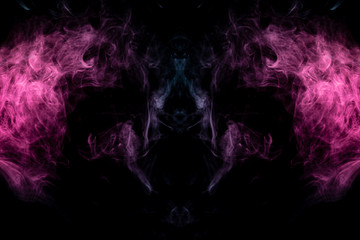 Smoke of different blue, red and pink colors in form of horror in the shape of the head, face and...