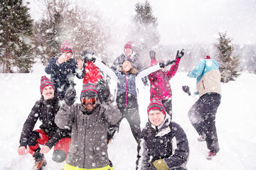 group of young people throwing snow in the air