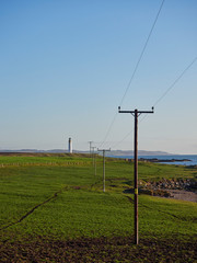 Fototapeta na wymiar Looking from the small Village of Usan, north up the East Coast of Scotland with the Lighthouse of Scurdie Ness in the Background. Montrose, Scotland.