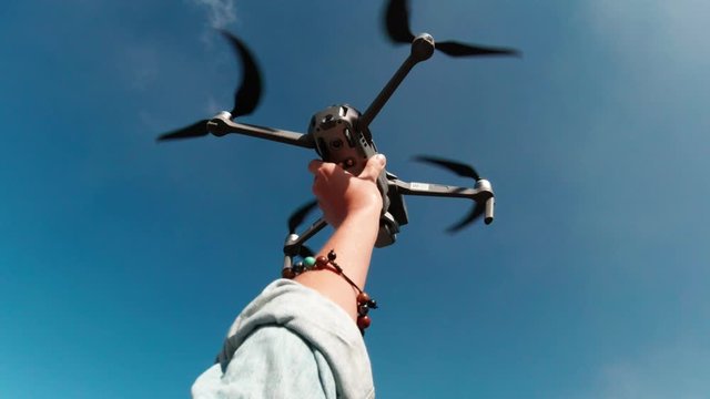 Female hand releasing drone to fly near the Mount Bromo volacno in East Java, Indonesia - video in slow motion
