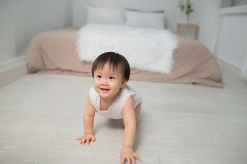 Fototapeta premium Little baby girl or girl crawling on floor in bed room