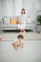 Little girl crawling on the floor in living room
