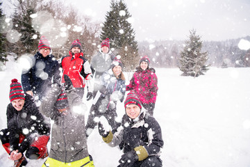group of young people throwing snow in the air