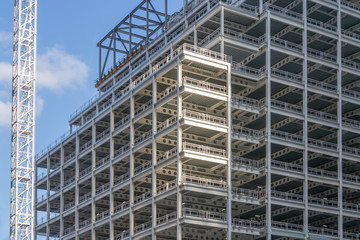 Industrial construction site background. Hoisting cranes and new multi-story buildings