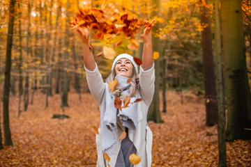 Casual young woman enjoying autumn season at forest