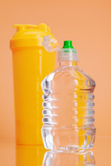 Plastic water bottles on a pastel beige background
