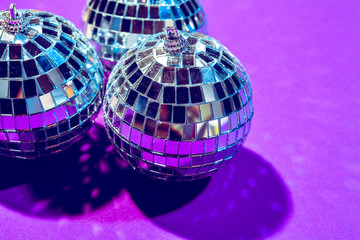 disco ball shines on purple background close up