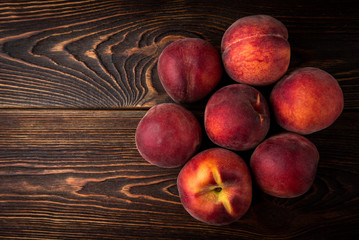 Peach on dark wooden background.